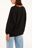 As Seen in Unique’s  Video: V Neck Tie Front Blouse in Black