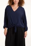 As seen in Unique’s Video: V Neck Front Tie Navy Blouse